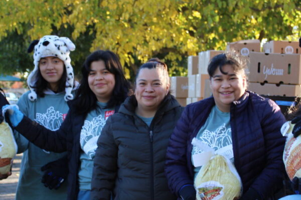 Food bank helpers with frozen turkeys