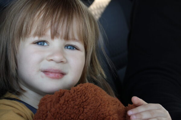 KID with stuffed animal from 2022 giveaway day