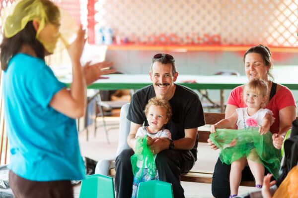 Volunteers help young children with parents