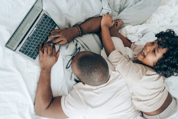 Dad works on computer with Child trying to get his attention